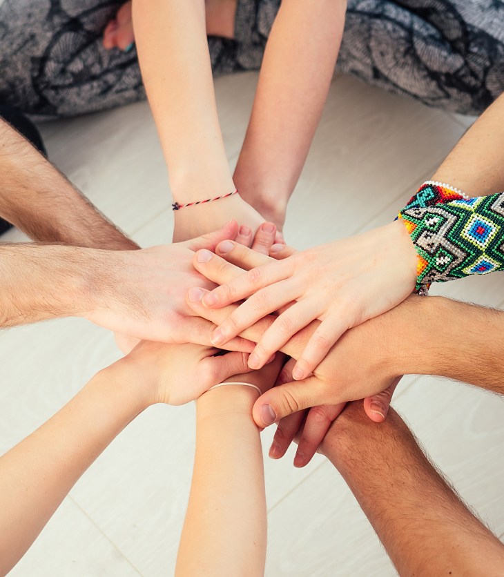 Happy group of people practicing yoga in the studio