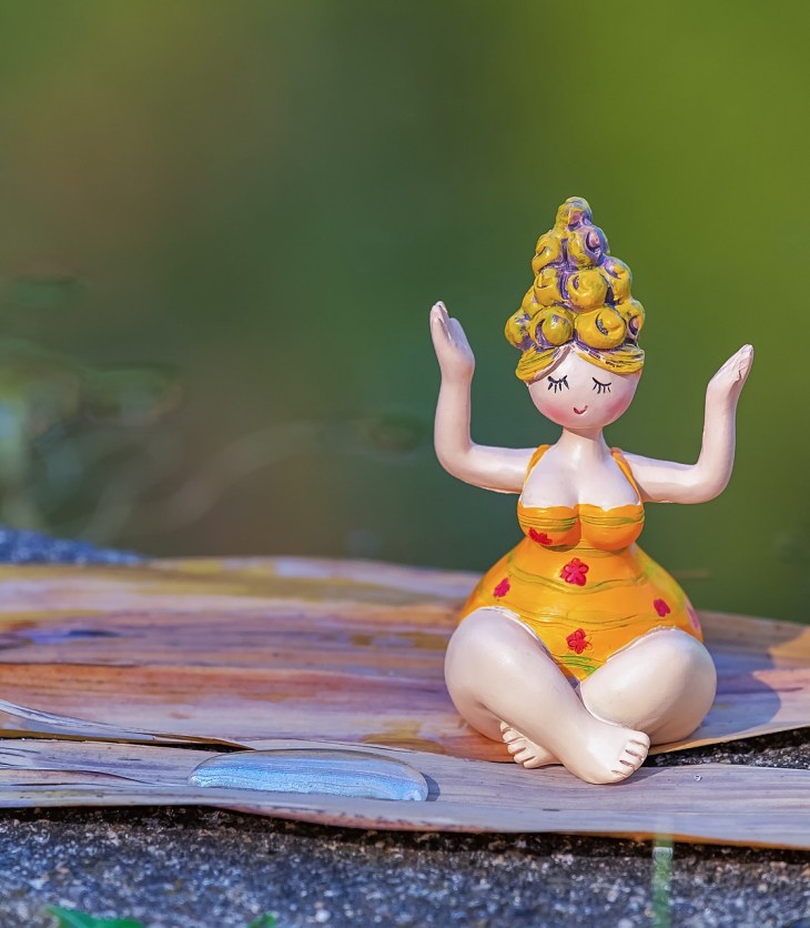 Little statue of a woman in meditation